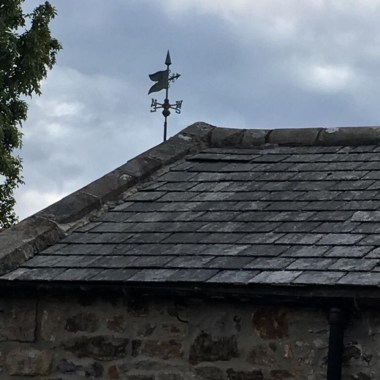 verdigris banner weathervane on old barn